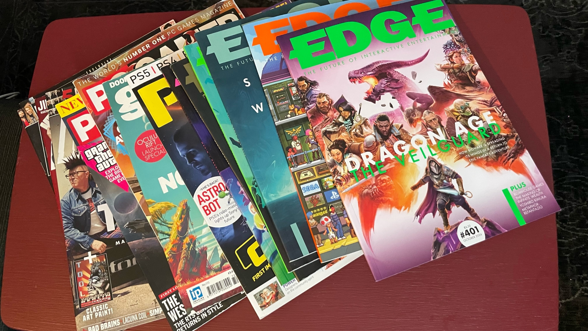 Photo of several magazines laying on a table, including issues of Edge, PC Gamer, and Kerrang.